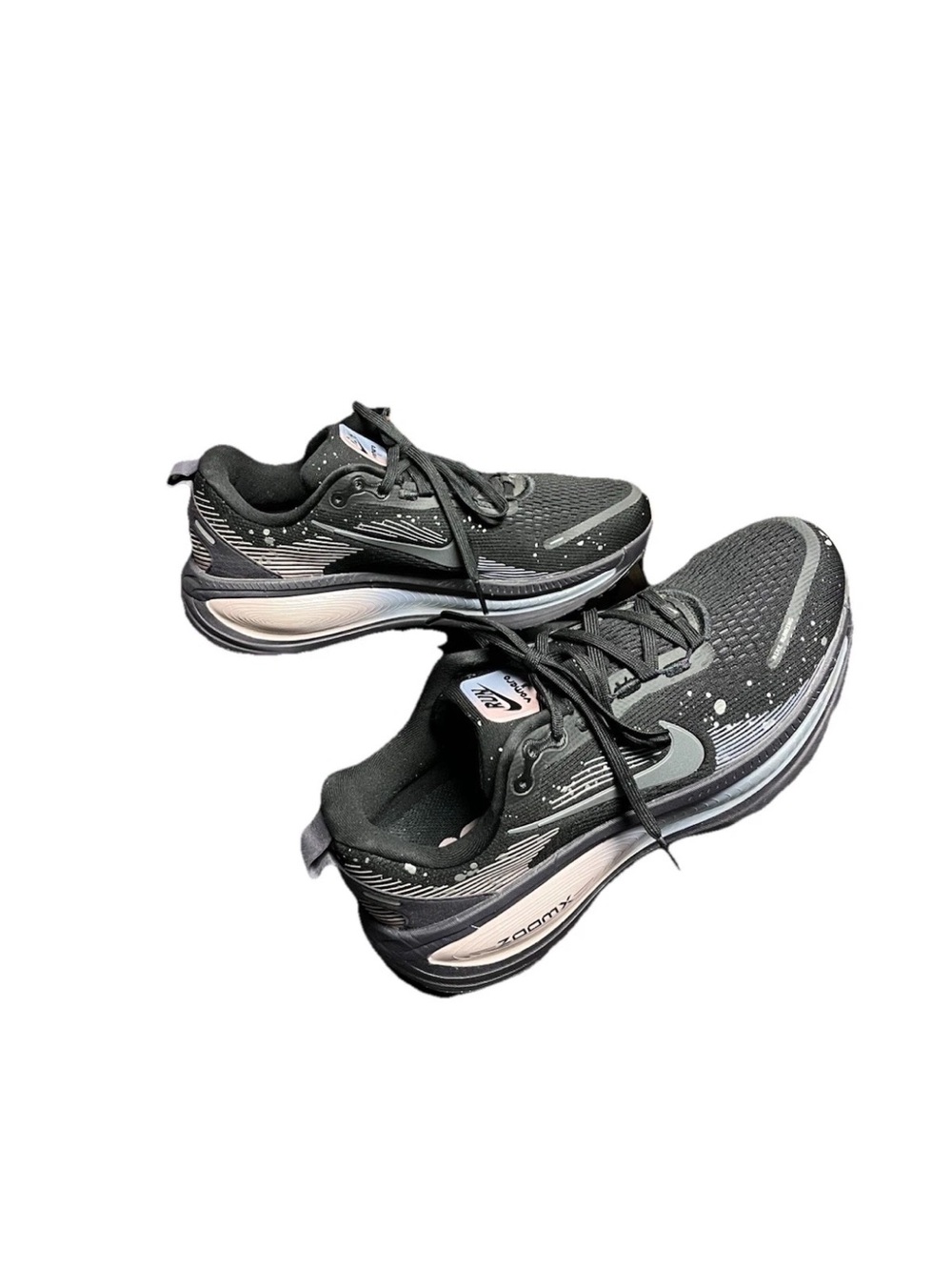 These are Nike Vomero 18 SE black and metallic dark grey sneakers.